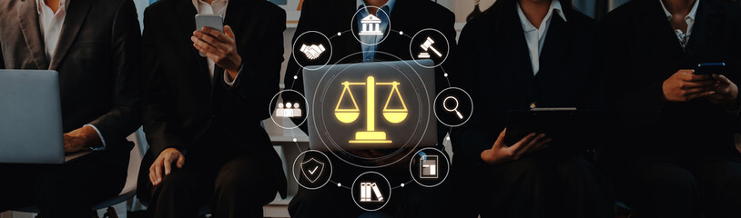 A diverse group of professionals engaged in a legal discussion, utilizing mobile devices and...