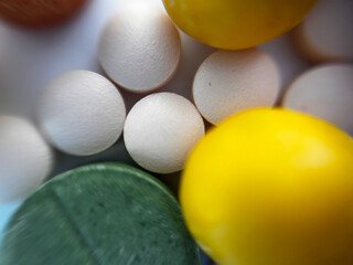 Macro photo of colorful medical pills and vitamins. Close up of pharmaceutical tablets in different shapes and colors on white background. Concept of healthcare, medicine, supplements and pharmacy.
