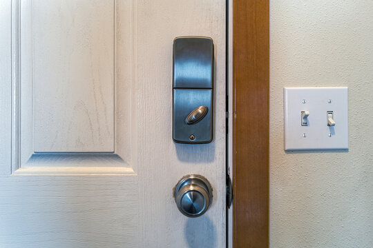 Light switches are conveniently placed next to the inside door of a residence