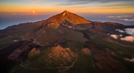 Fototapeta premium Majestic Volcano Summit Bathed in Golden Sunset Light Over Rolling Hills