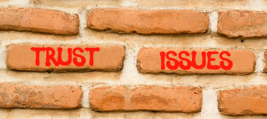 Trust issues symbol. Concept word Trust issues on beautiful old brown brick wall. Beautiful old...