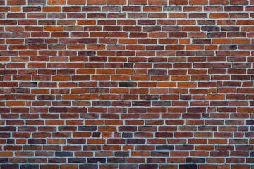 The texture of well-maintained red brick on the wall of a house