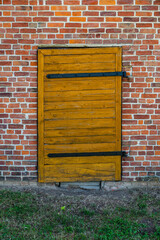 old wooden door in a red brick wall