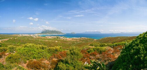 View of Golfo Aranci at Sardinia north, clear blue water beaches on both sides, from higher hill near