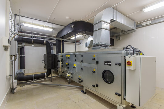 This scene features a central air handling unit in a mechanical room of a contemporary building