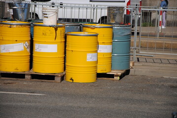 metal barrels with liquid materials for asphalt paving and road works