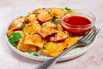fried ravioli with parmesan cheese, served with red sauce and garnished with herbs, on a light background, no people,