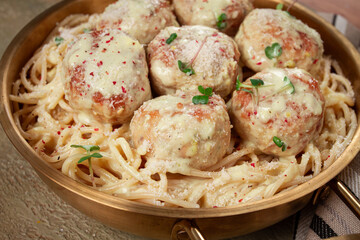 spaghetti with chicken meatballs, with cream sauce, and parmesan cheese, and decorated with microgreens, homemade, no people,