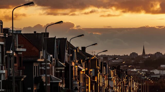 Row of houses along a street in warm sunset light, residential neighborhood architecture. Urban environment timelapse.