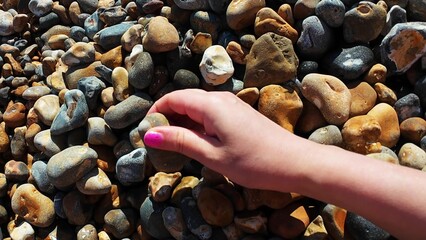Video shows people exploring rocks on a serene beach, connecting with nature