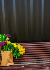  Flowers in Paper Bag Forgotten on Park Bench