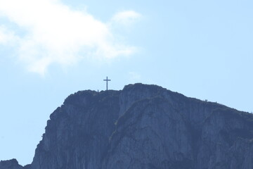 Cross of a mountain peak indicating the highest point and the hiking destination, summit marker, alpine landscape