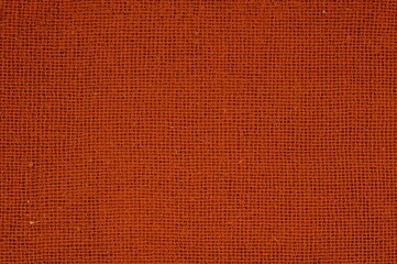 Fototapeta premium Close-up of dark orange fabric texture, detailed macro view.