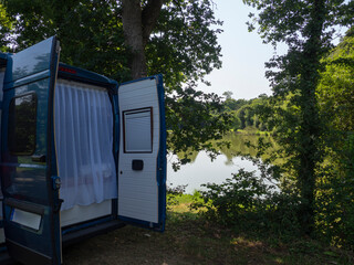 Furgoneta azul, acampada en el lago  de Francia llamado &Euml;tang du vivier de l'avent, en Saint Sauveur-le-Vicomte ,Normand&iacute;a , viajando en verano de 2025.