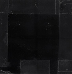 High-resolution black paper background with transparent stickers, tape marks, folds, and subtle texture. Perfect as a grunge overlay.