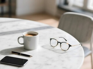 A white coffee mug, eyeglasses, pen, and smartphone on a bright marble table.
