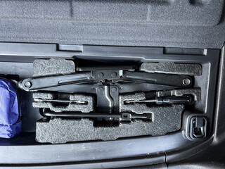 Essential car tools neatly organized in a storage compartment for roadside assistance and emergencies