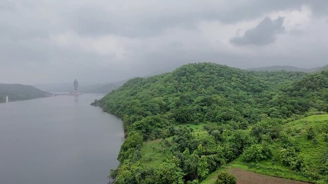 Narmada river and Statue of Unity surrounded by beautiful lush green mountains
