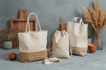 Textile eco-friendly bags displayed against a neutral grey background, highlighting environmental consciousness.