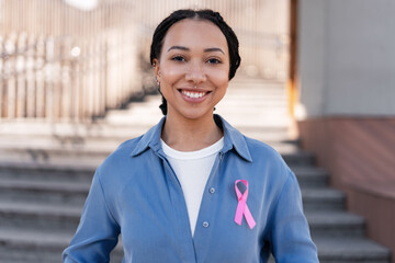 Woman wearing pink ribbon supporting breast cancer awareness