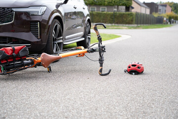 Car accident and a bicycle on the street there is a helmet lying next to it. © Ils