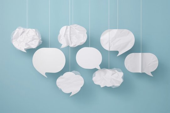 White empty speech balloons suspended on a string - Powered by Adobe