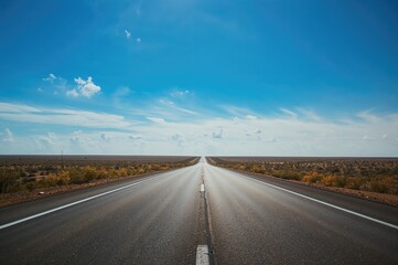 Fototapeta premium Desolate Highway Under Clear Azure Sky