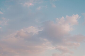 Fototapeta premium A peaceful dawn or dusk scene with gentle pastel colors and light, scattered clouds, evoking a sense of calm and serenity.