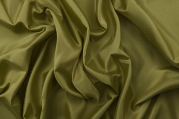 Obraz premium Olive green cloth with gentle folds and subtle shading, exuding elegance.
