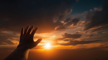 A human hand reaches toward the sky. Symbol of prayer, hope, and seeking God’s guidance and divine support.
