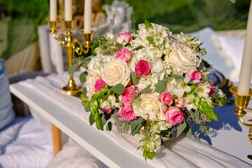 Romantic outdoor proposal setup featuring a transparent dome decorated with candles and floral arrangements