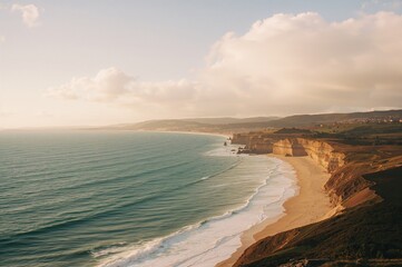Coastal scenery featuring the sea, beach, and autumn light with waves under a vast sky