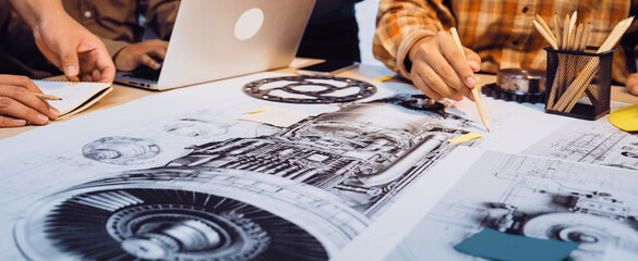 A team of engineers engaged in a brainstorming session, surrounded by technical drawings and modern technology, focused on designing an aircraft engine in an innovative workspace. SACTR