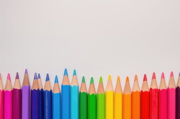 Detailed view of vibrant pencils lined up on a simple white surface, symbolizing creativity and learning