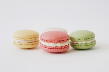 Trio of vibrant pastel macarons against a clean white backdrop