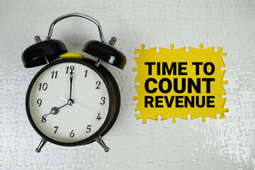 Time To Count Revenue text with alarm clock on yellow background