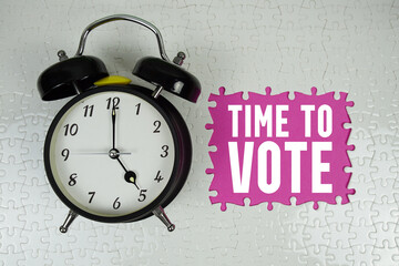 Time to Vote text with alarm clock on pink background