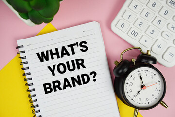 Budget Planning text written on notepad with calculator and alarm clock on pink background