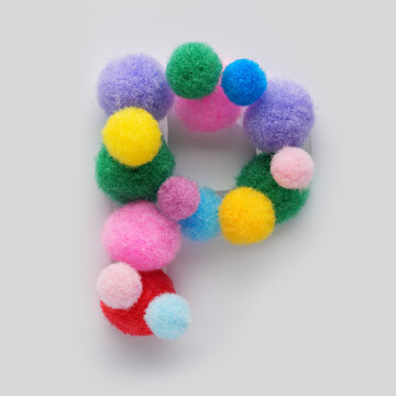 Colorful letter P made of fluffy pom poms on white background. Creative handmade typography for kids learning alphabet, educational design, playful classroom decor, and graphic projects.