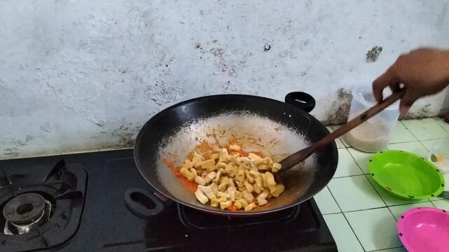 Footage. Yellow tofu cooked into spicy Balado-style stir-fried tofu. Indonesian spicy tofu. Balado tahu.