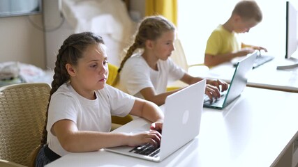 Children type on laptop together child and kid concentrate on computer task during study and learning session while girl and boy sit at desk in classroom education setting with focused expression - Powered by Adobe