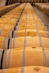Fototapeta premium Visit of undergroud caves witn wine barrels in Cahors wine production area, red malbec wines, wine tasting in chateau, France