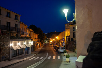 Panoramic view of colourful Collioure at night, narrow streets and yellow, pink, orange houses,...