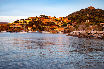 Fototapeta premium Sunset view of colourful Collioure, narrow streets and yellow, pink, orange houses, summer vacation destination town with historical buidings and beaches, Pyrenees-Orientales, France