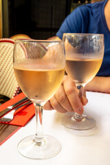 Lunch in french bistro with glass of cold rose wine in summer, Toulouse, France