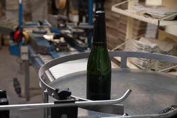Process of putting foil on champagne bottles in caves, traditional method of production of cremant, blanquette sparkling wine Limoux, Occitania, France