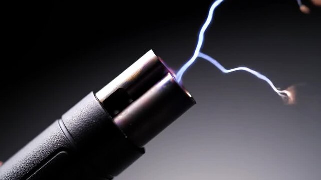 Dynamic close-up of a stun gun firing a crackling high-voltage electric arc against a dark background.