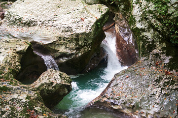 A breathtaking canyon filled with crystal-clear water that perfectly mirrors the towering rock walls rising from its surface.