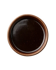 a small. round brown ceramic bowl filled with a thick. dark brown sauce or condiment the glossy surface reflects light. indicating a rich texture. commonly used in cooking or as a dip culinary themes