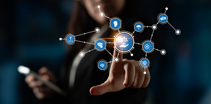 A businesswoman engages with an interactive digital interface showcasing various legal symbols and technology concepts, representing the intersection of law and innovation. Tessel